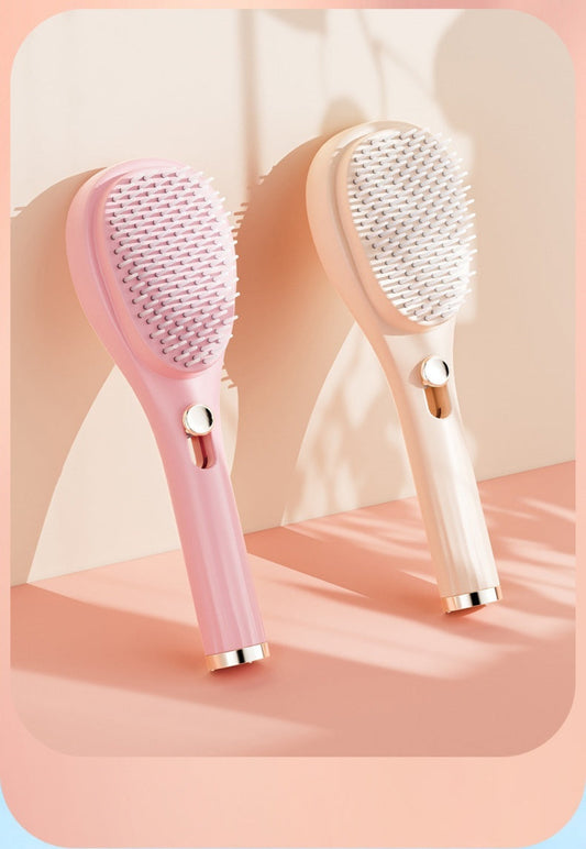 Two pink and white hairbrushes on a light pink background