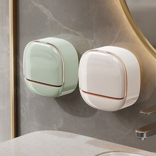 Two wall-mounted soap dispensers, one green and one white, on a bathroom wall.