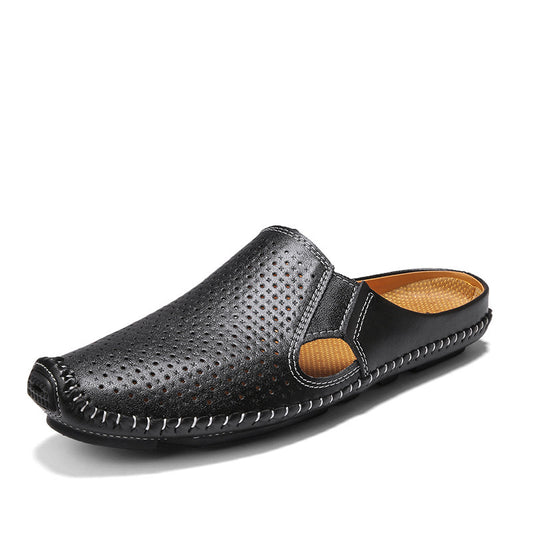 Black perforated slip-on shoe with brown interior on a white background