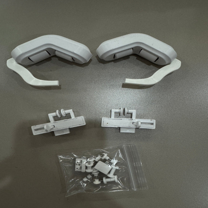 Set of white plastic components on a gray background