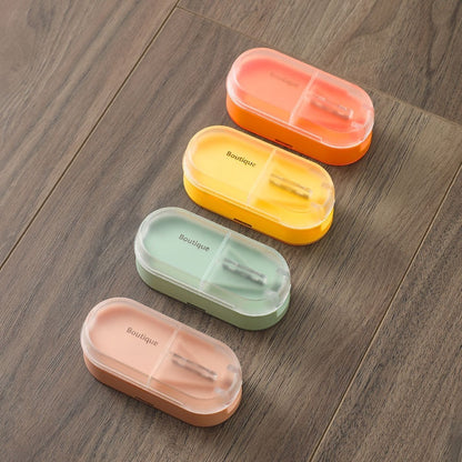 Four colorful pill boxes on a wooden surface