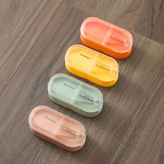 Four colorful pill boxes on a wooden surface