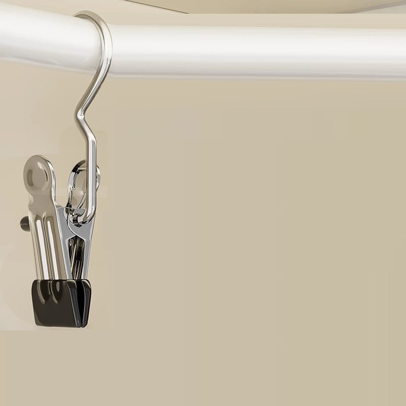 Metal clip attached to a white rod on a beige background
