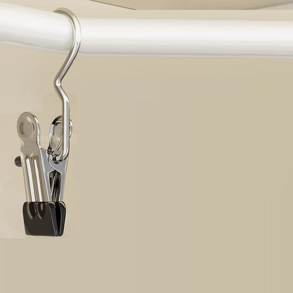 Metal clip attached to a white rod on a beige background