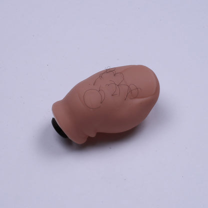 Small brown object with writing on a white background
