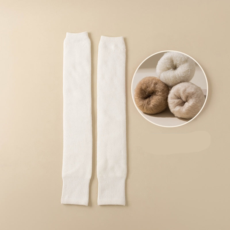 White leg warmers on a beige background with a close-up inset of brown and white yarn balls.