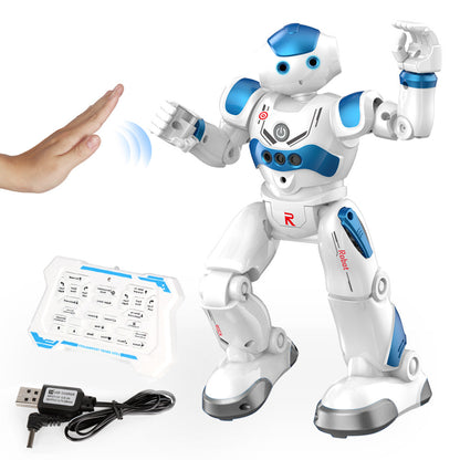 White and blue robot toy with remote control and USB cable on a white background
