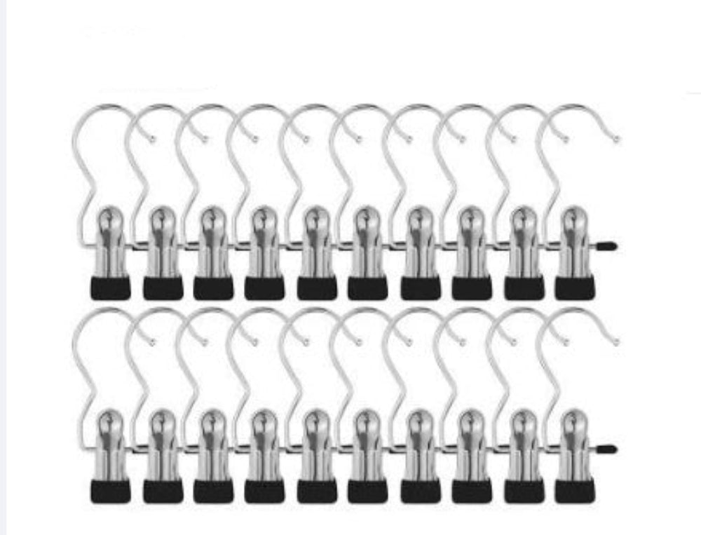 Set of 20 metal hangers with black clips on a white background