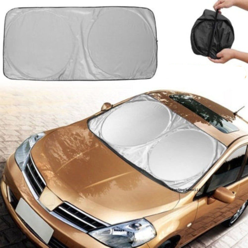 Car sunshade on a gold car with a hand holding a carrying case above.