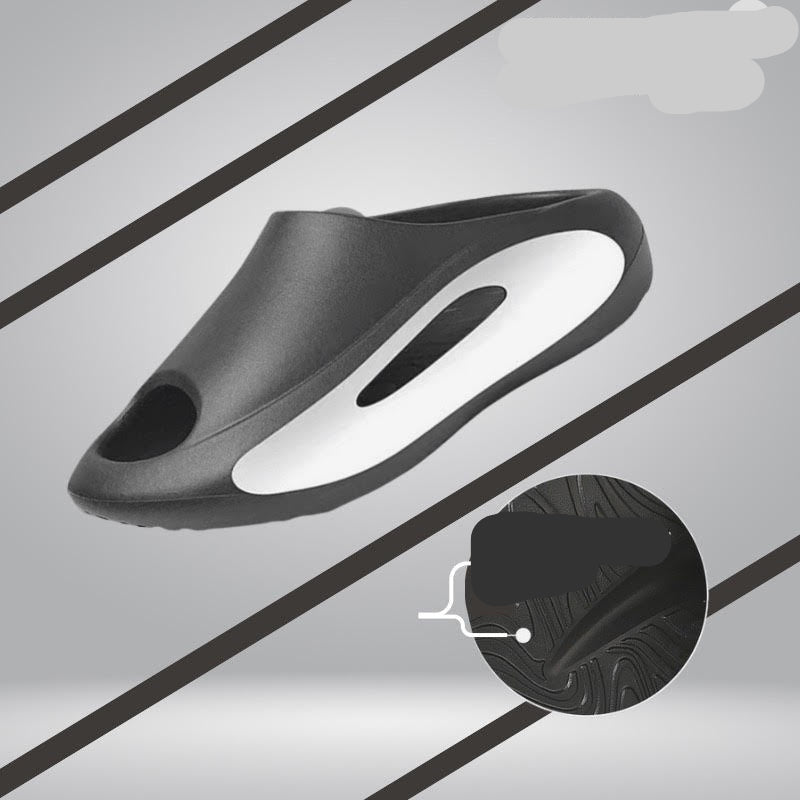 Black slip-on shoe with a slick resistant design on a gray background