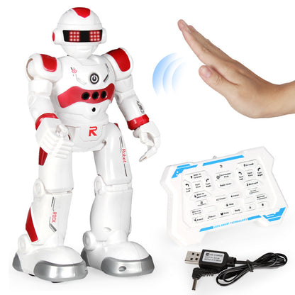 White and red robot toy with remote control and USB cable on a white background