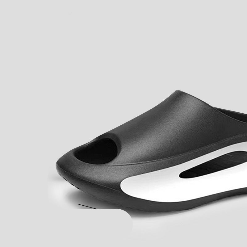 Black and white shoe with anti-collision design feature on a gray background
