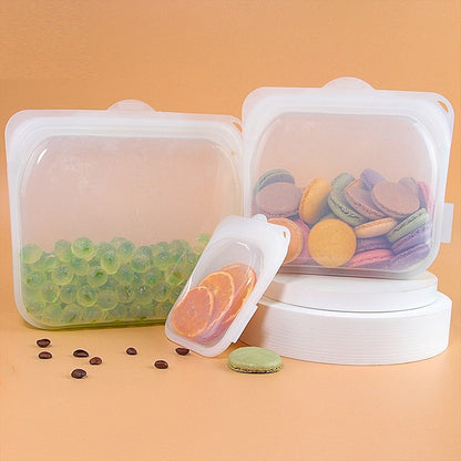 Set of silicone food storage containers with various contents on a peach background