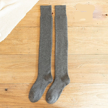 Dark grey knee-high socks on a wooden surface with 'Dark grey' text.