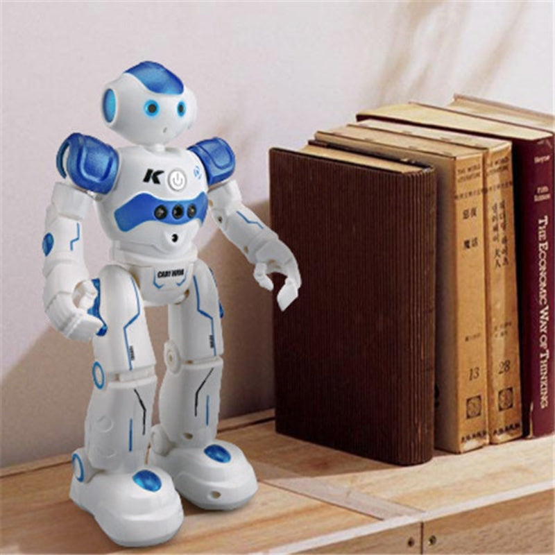 White and blue robot toy on a wooden surface with books in the background