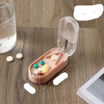 Pink pill organizer with colorful pills on a wooden surface, next to a glass of water.