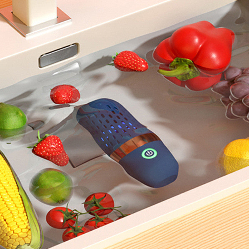 Blue kitchen device with fruits and vegetables on a reflective surface