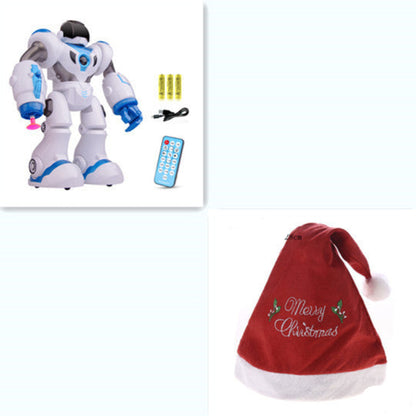 Toy robot with remote control, batteries, and a red Christmas hat on a white background