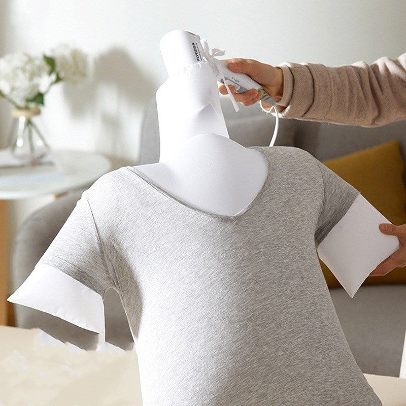 Person using a garment steamer on a gray shirt on a mannequin.