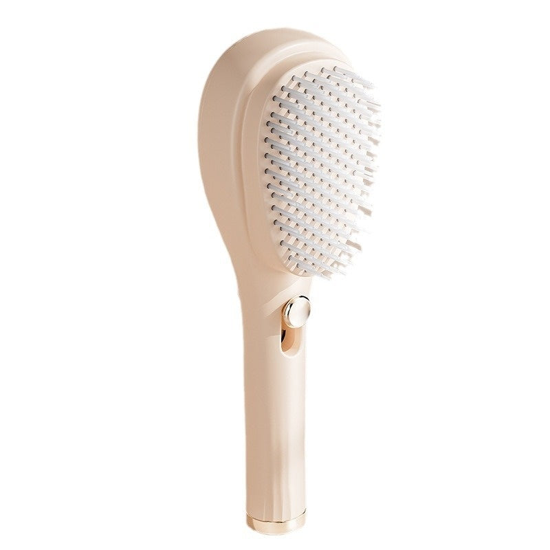 Beige hairbrush with bristle head on a white background