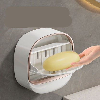 Wall-mounted soap dispenser with a bar of soap, on a neutral background.