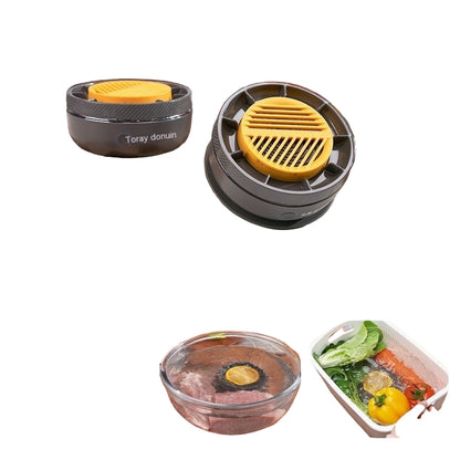 Two black and yellow kitchen tools on a counter with vegetables and a cutting board in the background.