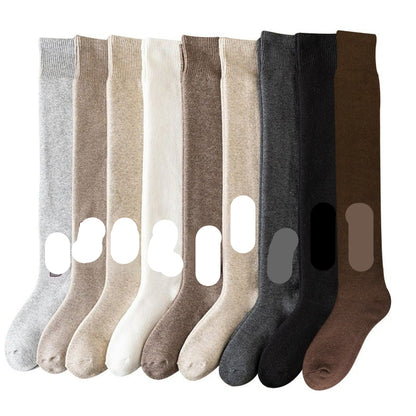 Set of eight pairs of socks in various colors with color names on a white background
