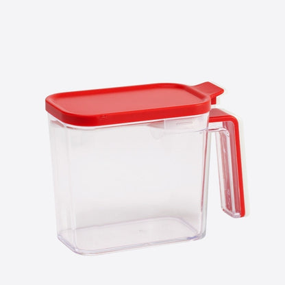 Clear container with red lid and handle on a white background