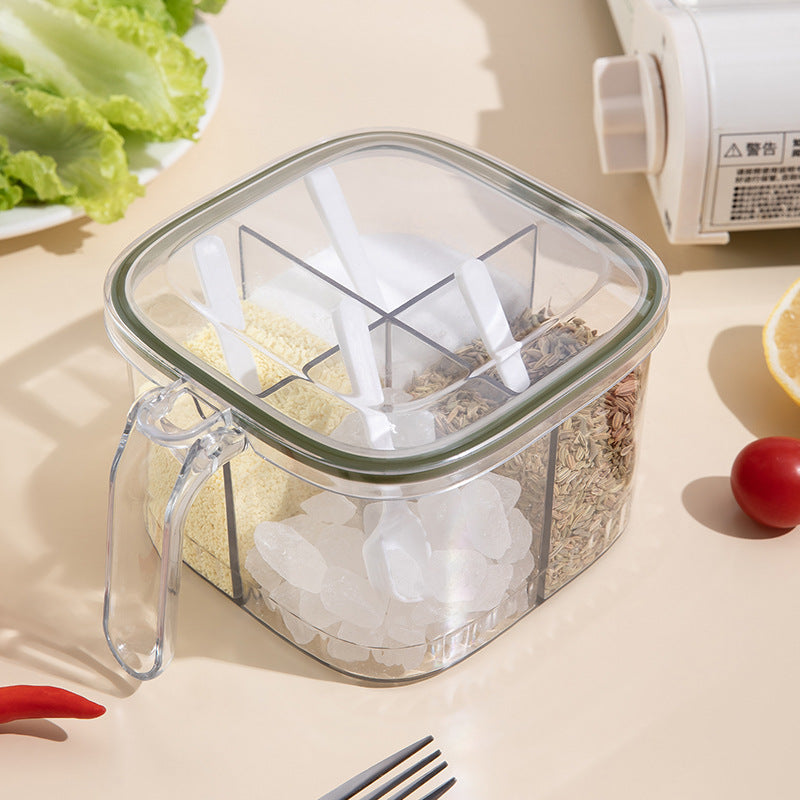 Clear food storage container with compartments on a table with vegetables and a bottle.