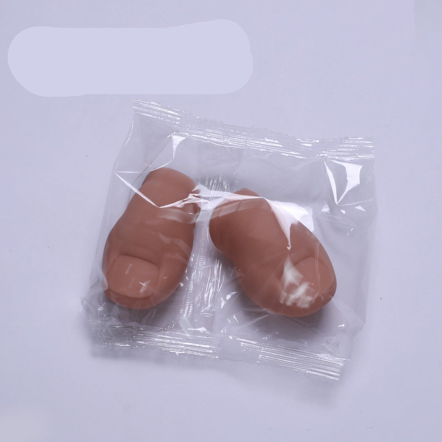 Two brown feet in clear plastic packaging on a white background with the word 'Bald' above.