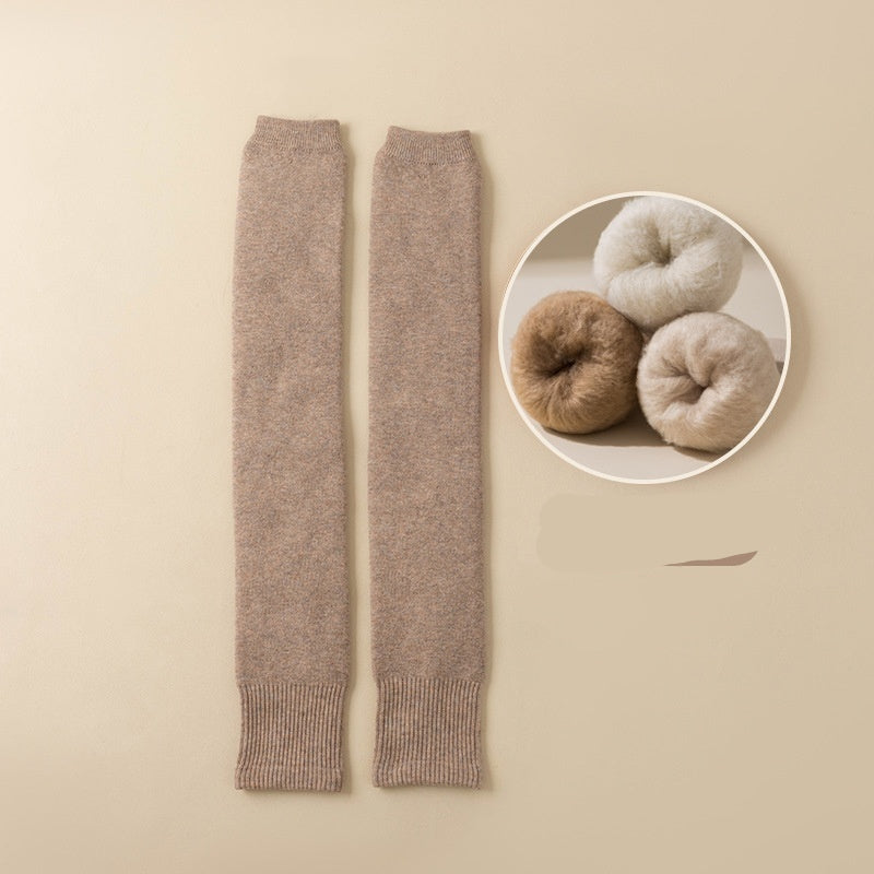 Light coffee-colored leg warmers with a close-up of yarn balls on a beige background