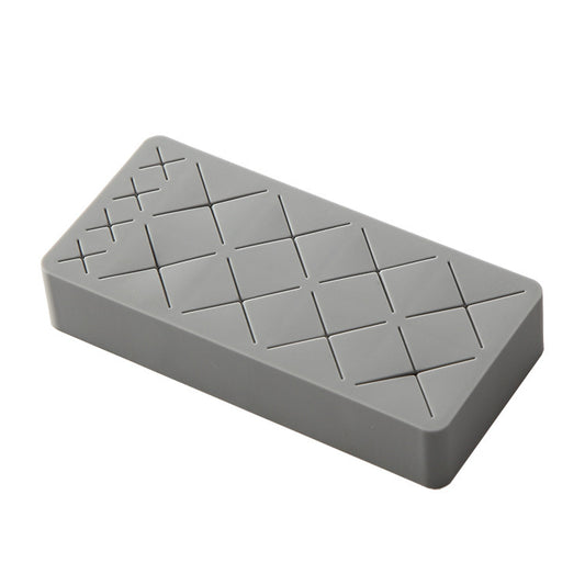 Gray ice cube tray with diamond pattern on a white background