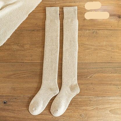 Pair of off-white knee-high socks on a wooden surface with 'Off-white' text.
