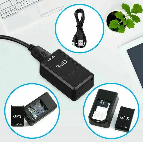 Black GPS device with close-up insets on a desk with a laptop and plant.
