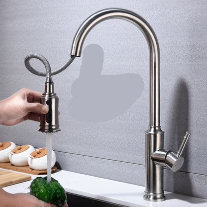 Kitchen faucet with pull-down spray wand on a gray tiled wall background