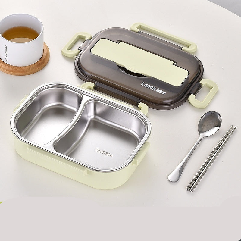 Two-grid green lunch box with compartments, lid, spoon, and chopsticks on a white background.