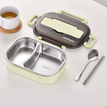 Two-grid green lunch box with compartments, lid, spoon, and chopsticks on a white background.