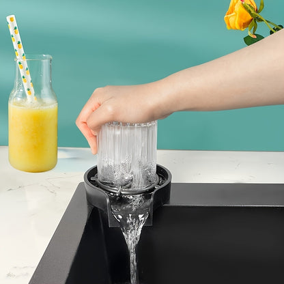 Person using a countertop juicer with a glass of orange juice and a bottle of juice in the background.