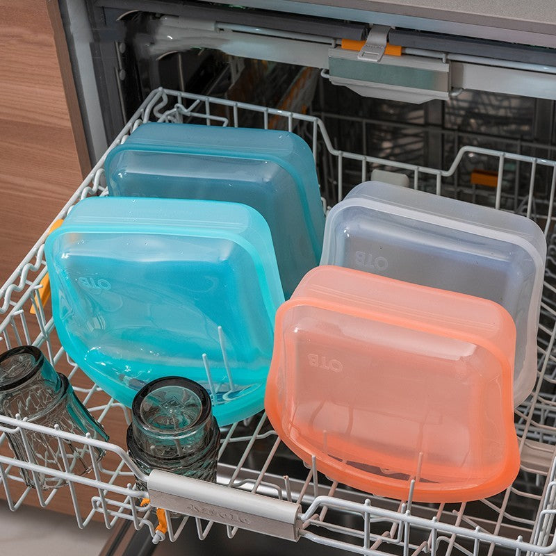 Dishwasher with open door showing stacked plastic containers and jars.
